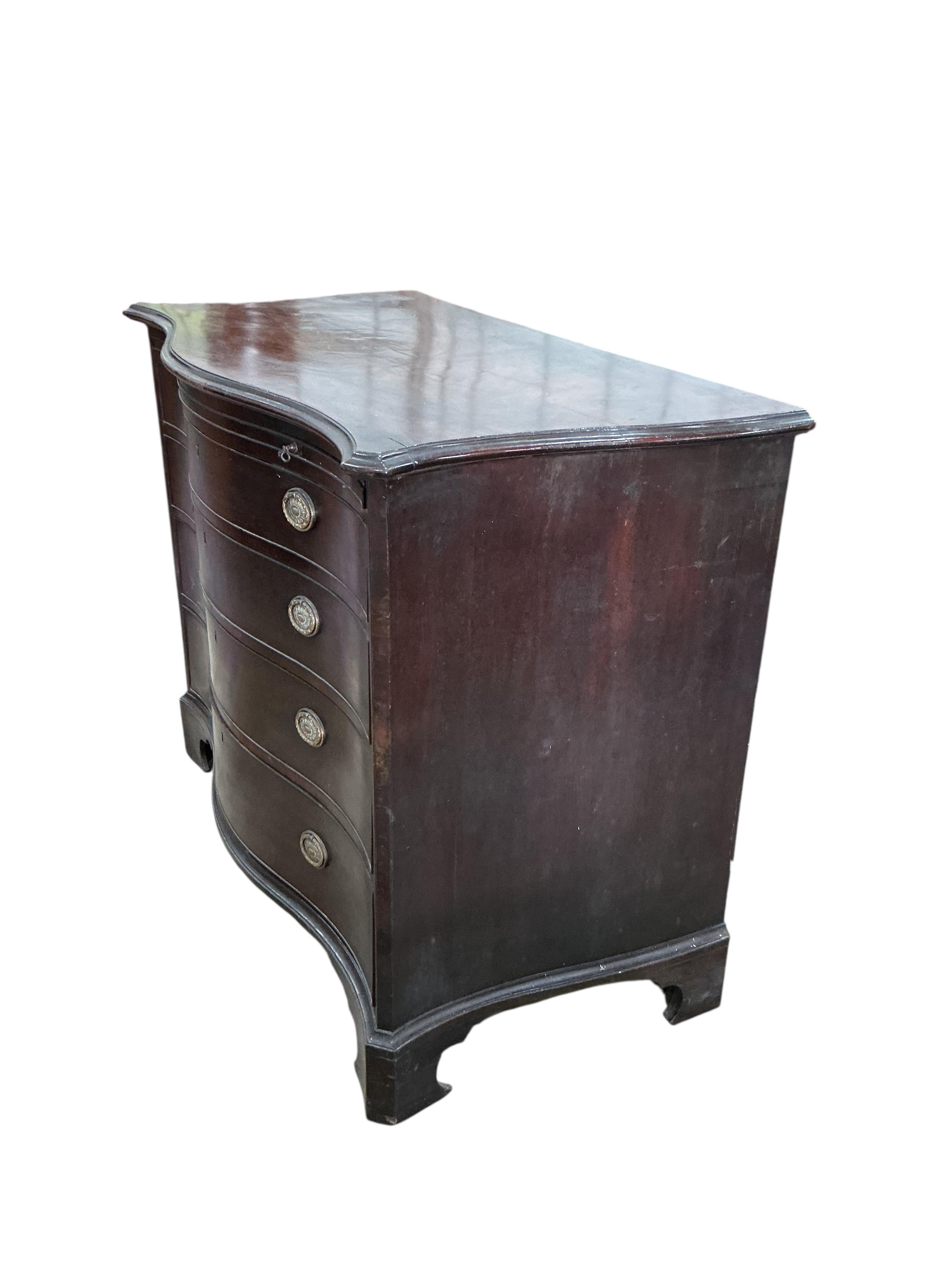 A George III mahogany serpentine chest, with brushing slide, width 111cm, depth 57cm, height 93cm
